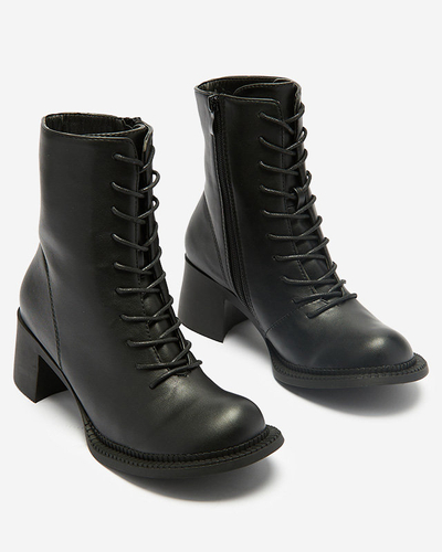 Dámské černé kozačky s kotníčkovými botami na sloupku Caretti. Obuv