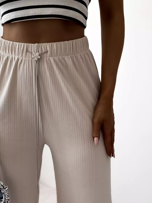 Бежеві жіночі широкі брюки в рубчик - Одяг