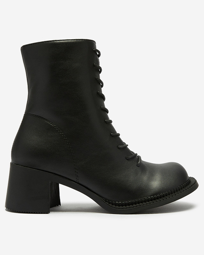 Dámské černé kozačky s kotníčkovými botami na sloupku Caretti. Obuv